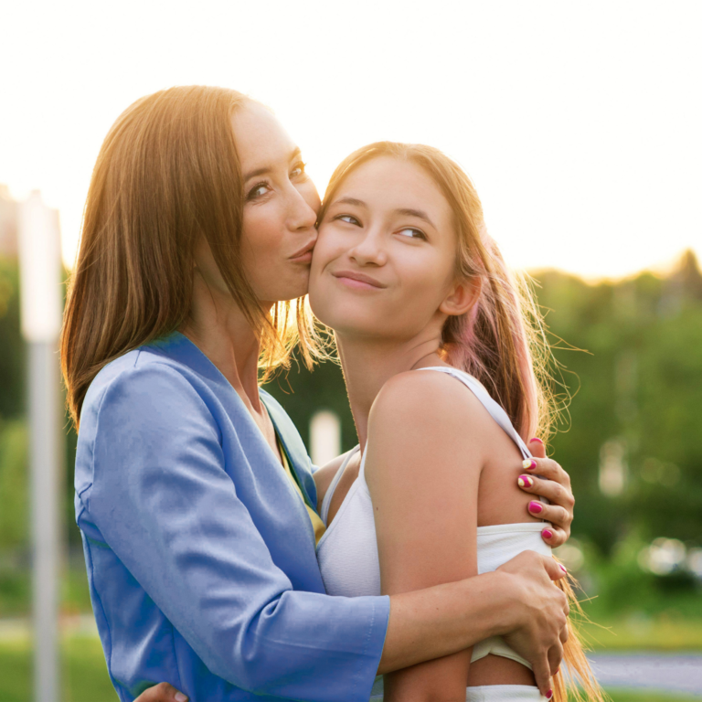 Mom hugging teen daughter